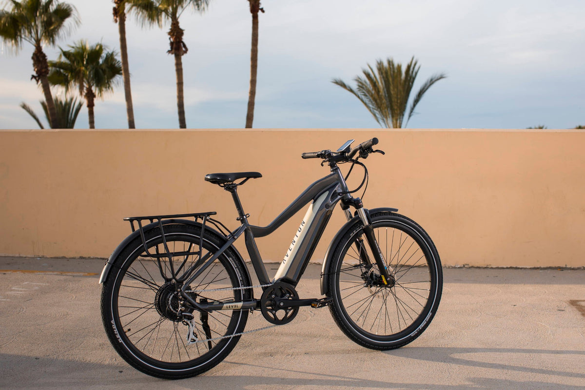 Aventon Level commuter e-bike parked in front of a sunlit wall